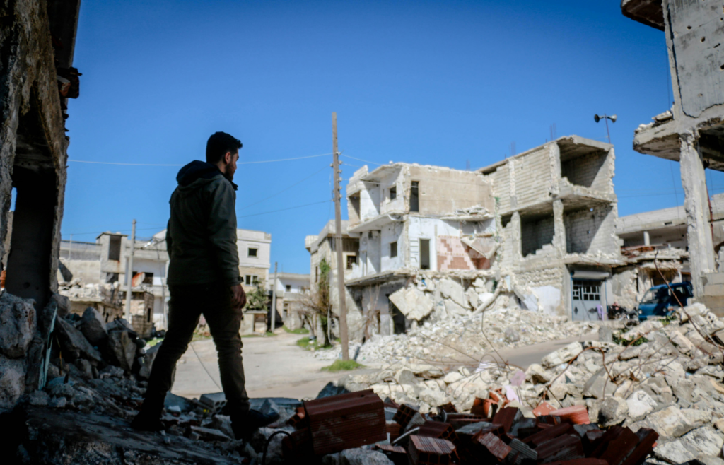A destroyed city street with debris from buildings