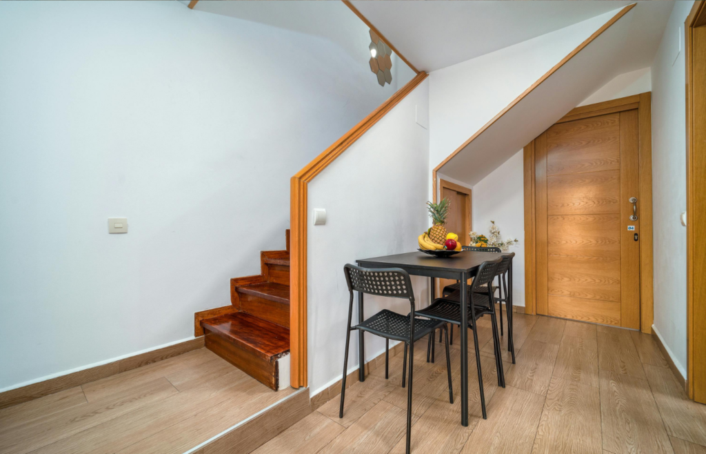 A door opening under a staircase