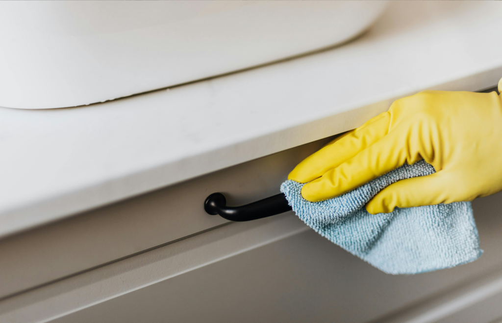 A hand opening a hidden panel or drawer under a counter