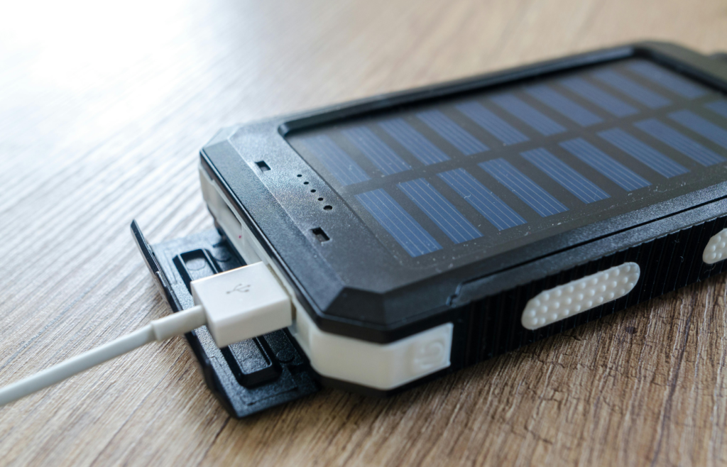 A solar panel charging a phone