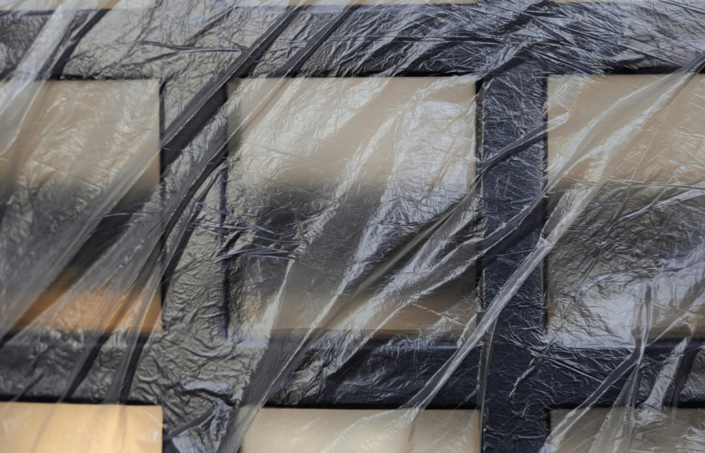 A clear plastic sheet taped 