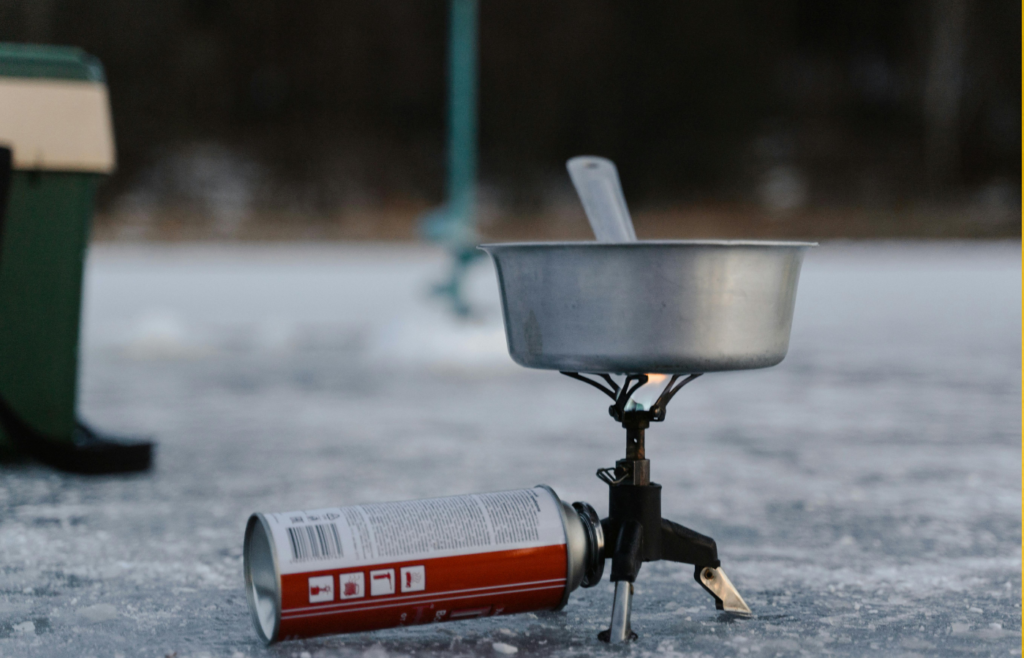 A Stainless Pot on a Camping Stove with a Can of Butane