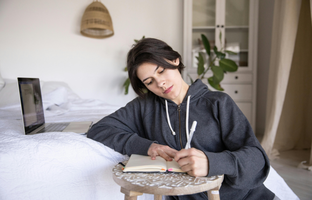 A woman sitting with a notebook 