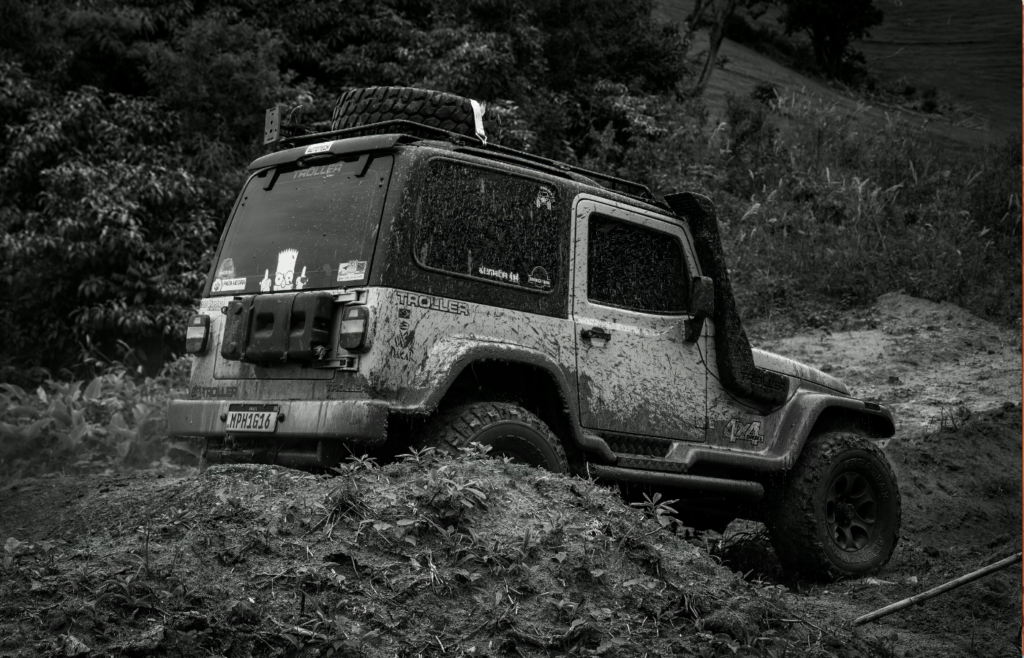 Black and White Photo of a Vehicle in the Mud