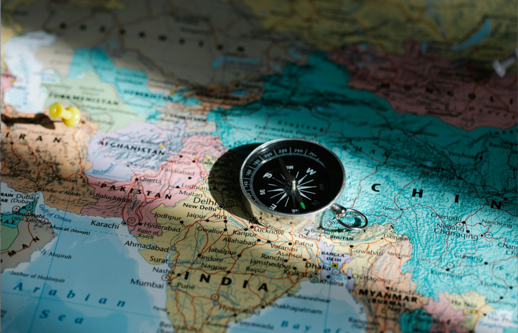 Compass placed on a world map