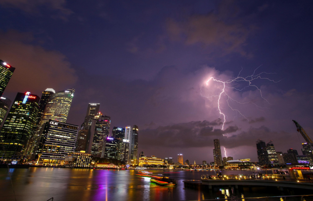 A lightning strike hitting a cityscape at night.