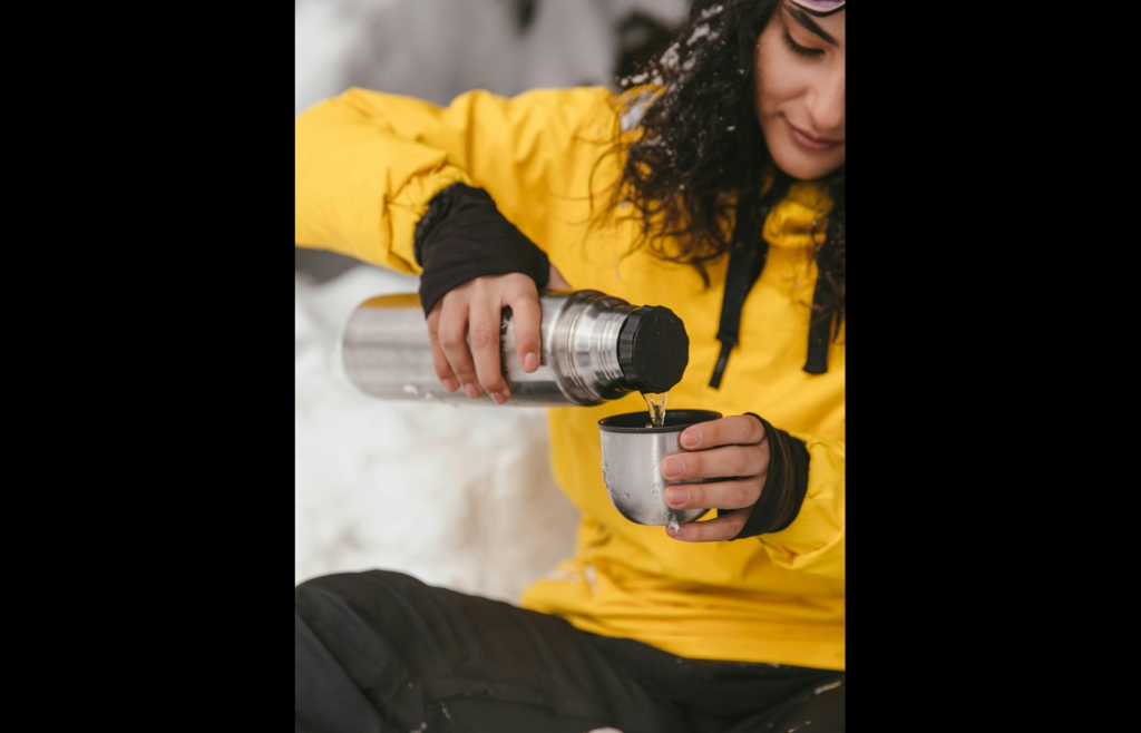 Woman Pouring Water from a Stainless Water Bottle