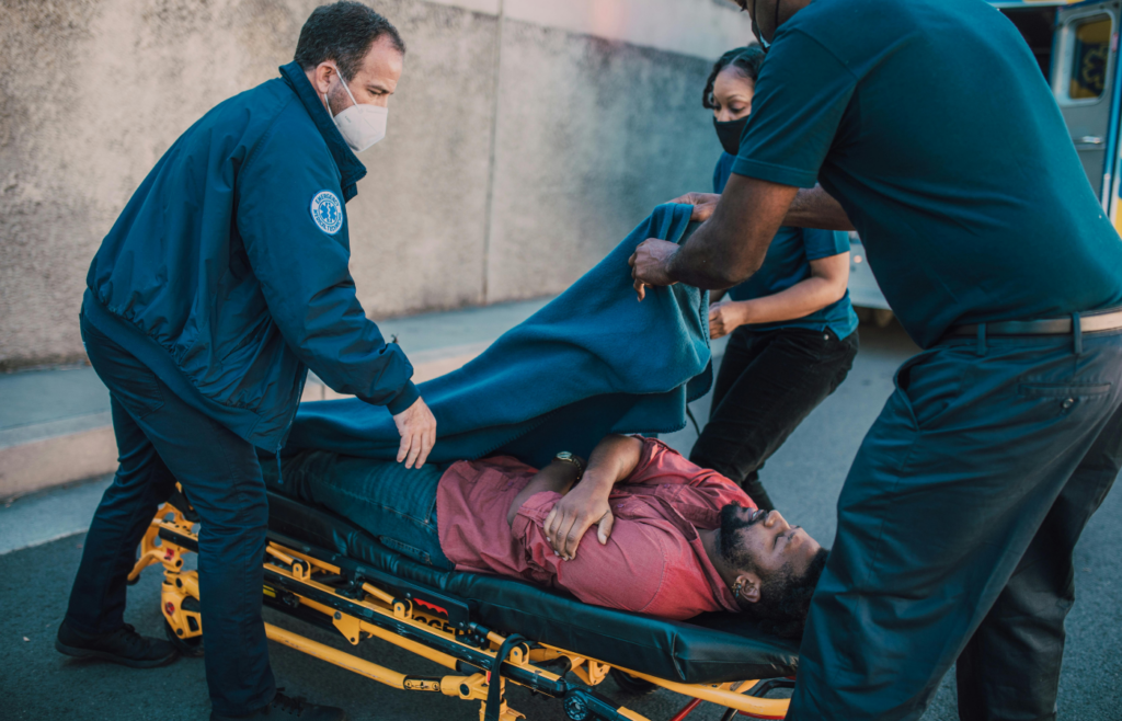 Paramedics Putting a Blanket on a Man's Body