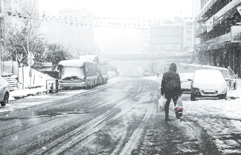 Man Walking on a Snow Covered Street