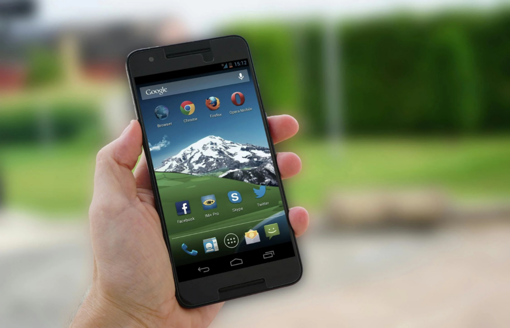 Smartphone in someone’s hand showing a mountain