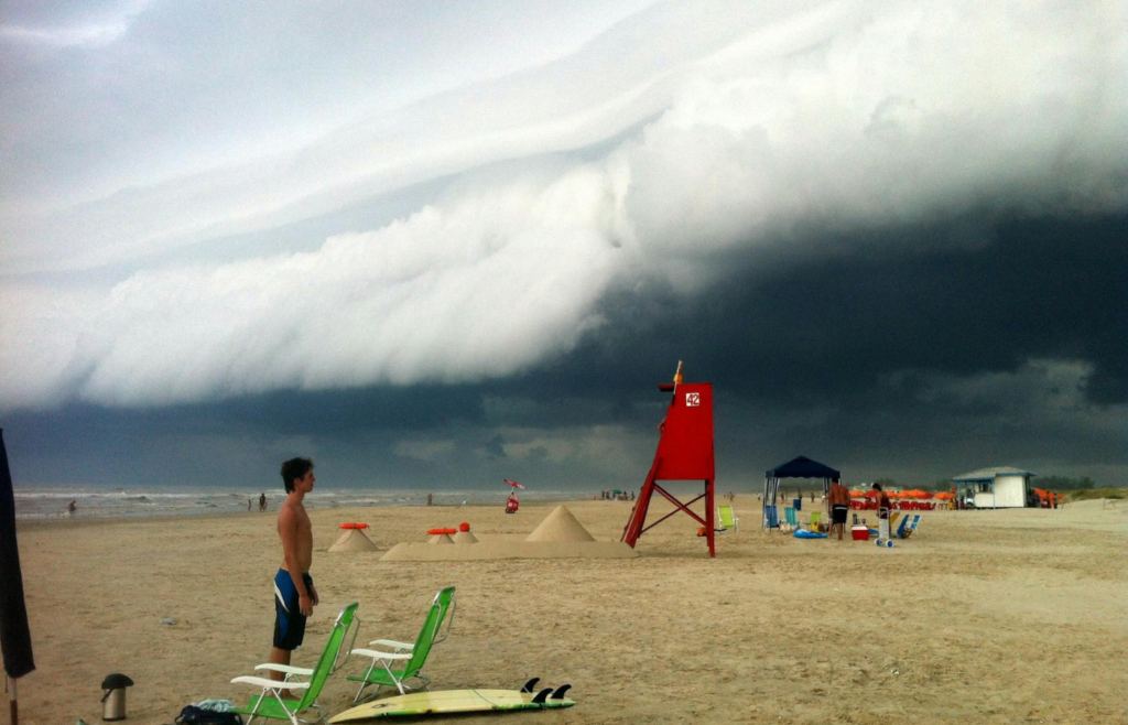 Ominous storm clouds rolling over beachgoers