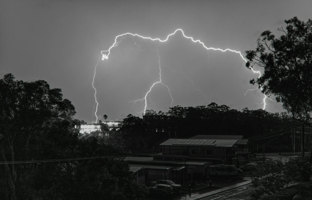 A night sky with flashes of lightning