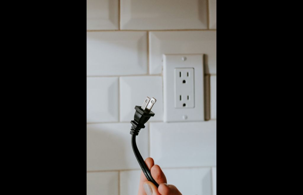 black usb cable plugged in white electric socket