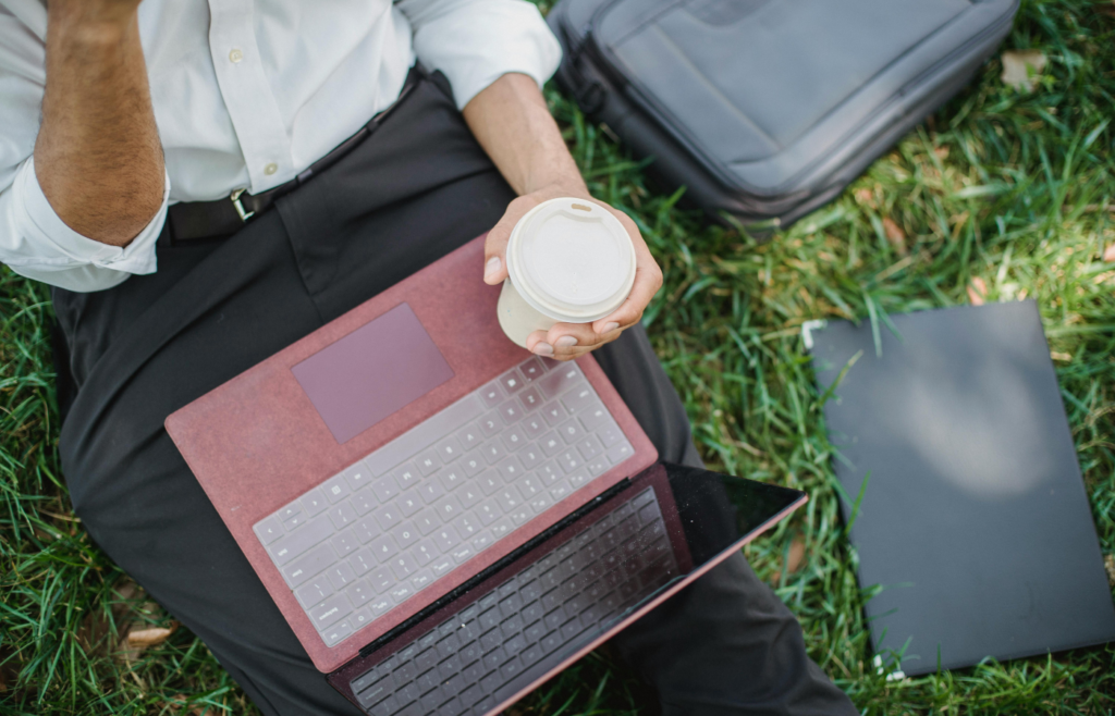 Close-Up Photo of a Person Holding a Disposable Cup