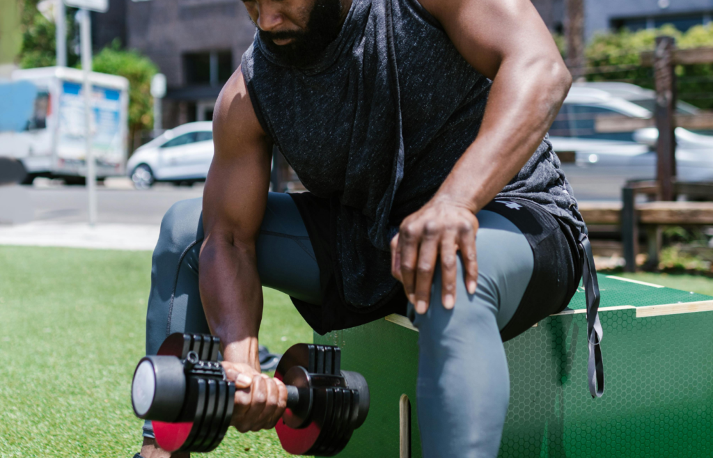 Individual exercising outdoors with basic fitness equipment