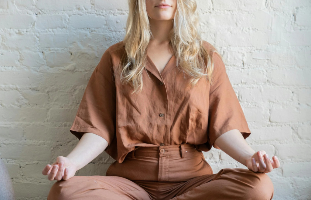 Person meditating or practicing stress-relief techniques