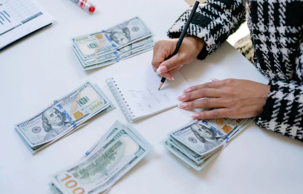 Person reviewing personal budget and emergency fund savings