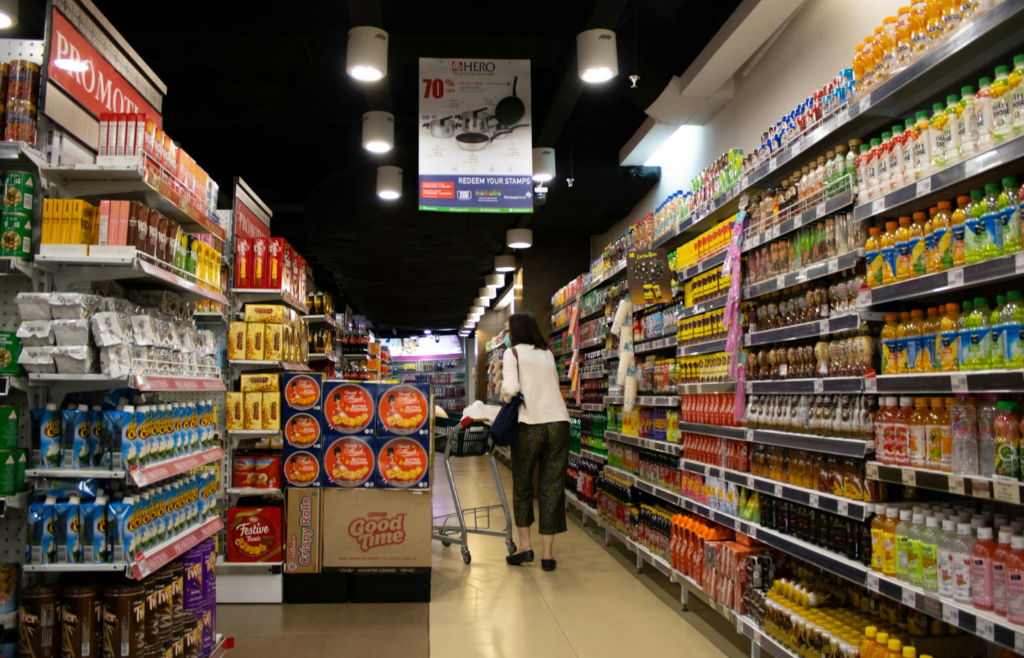 Shelves stocked with canned goods and bottled water