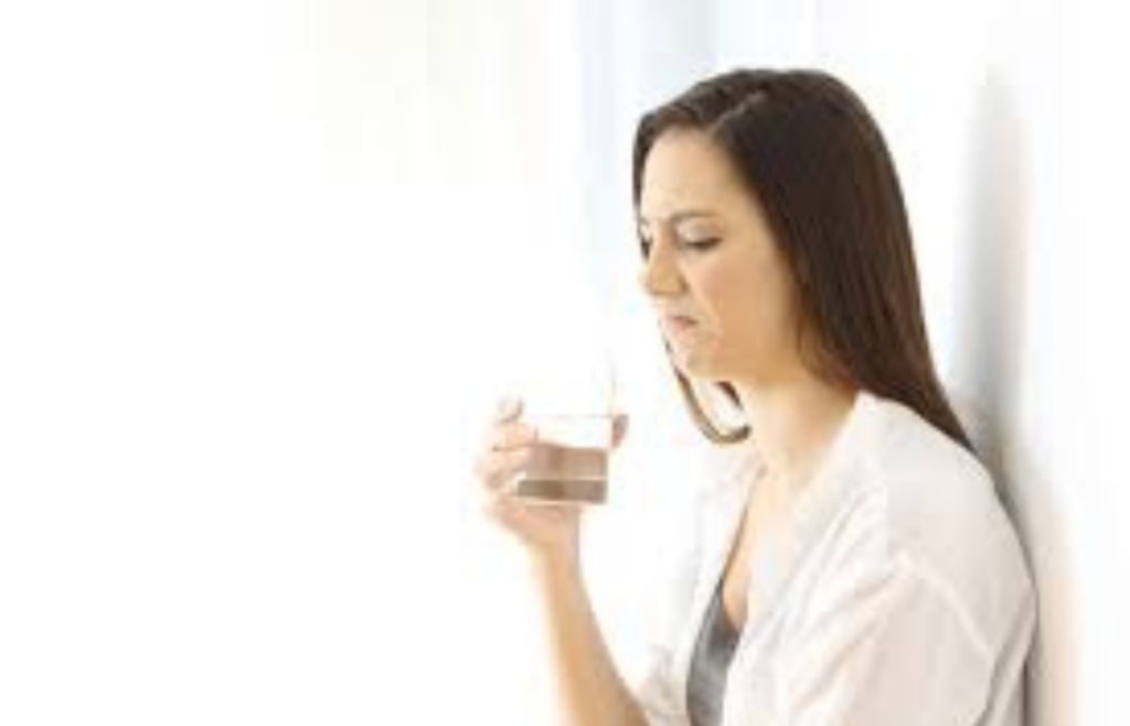 Person grimacing after tasting water