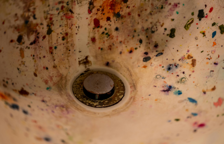 Sink with blue-green stains around the drain