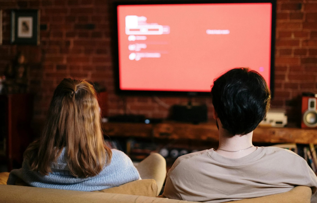 A couple watching a weather forecast together