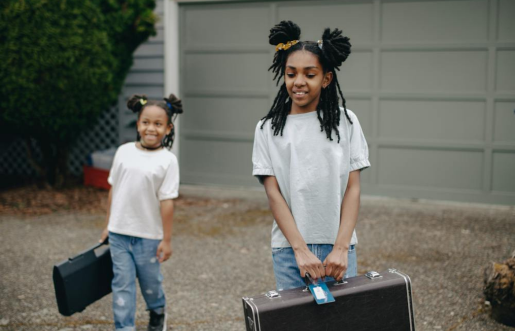 Two girls evacuating their home with emergency bags