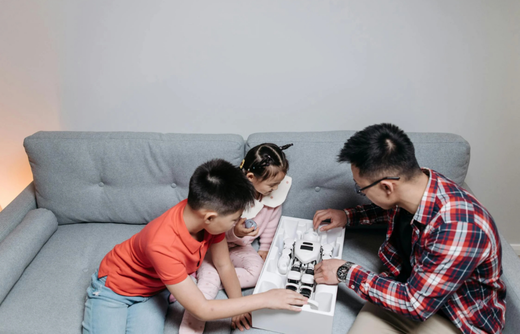 A family sitting idly in a living room without electronics