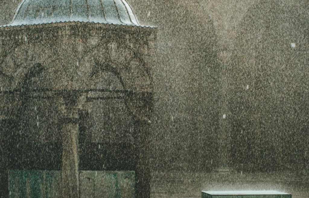Heavy rain falling on ancient structure