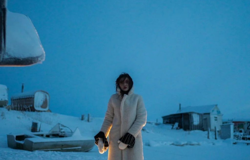 Woman in heavy coat braves snowstorm