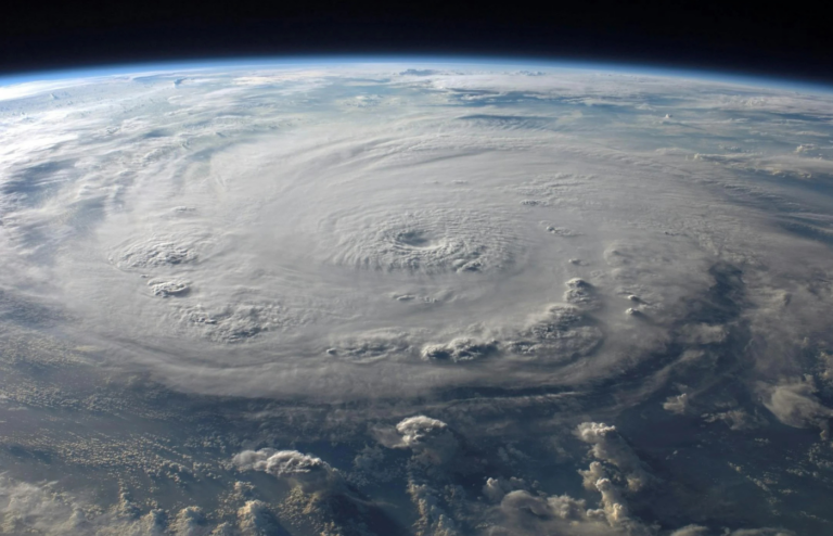 A massive hurricane spirals over the ocean, captured from space