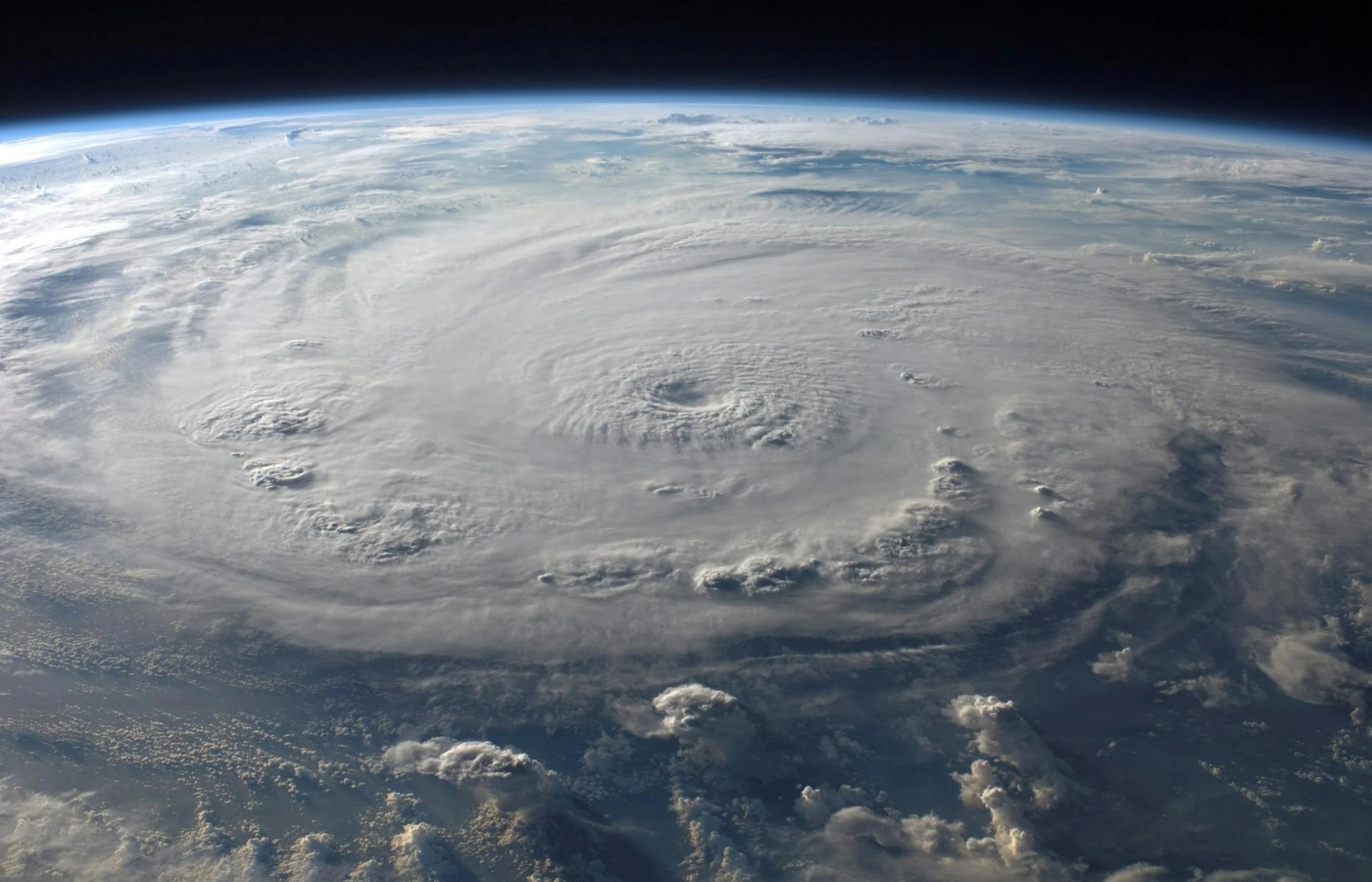 A massive hurricane spirals over the ocean, captured from space