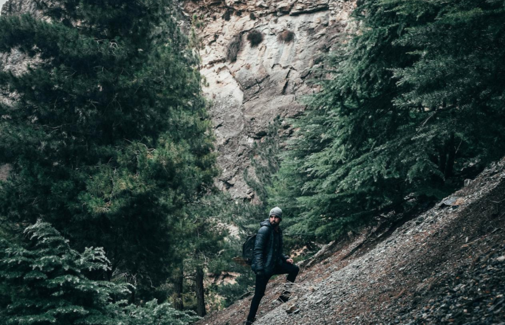 A person climbing a steep mountain trail