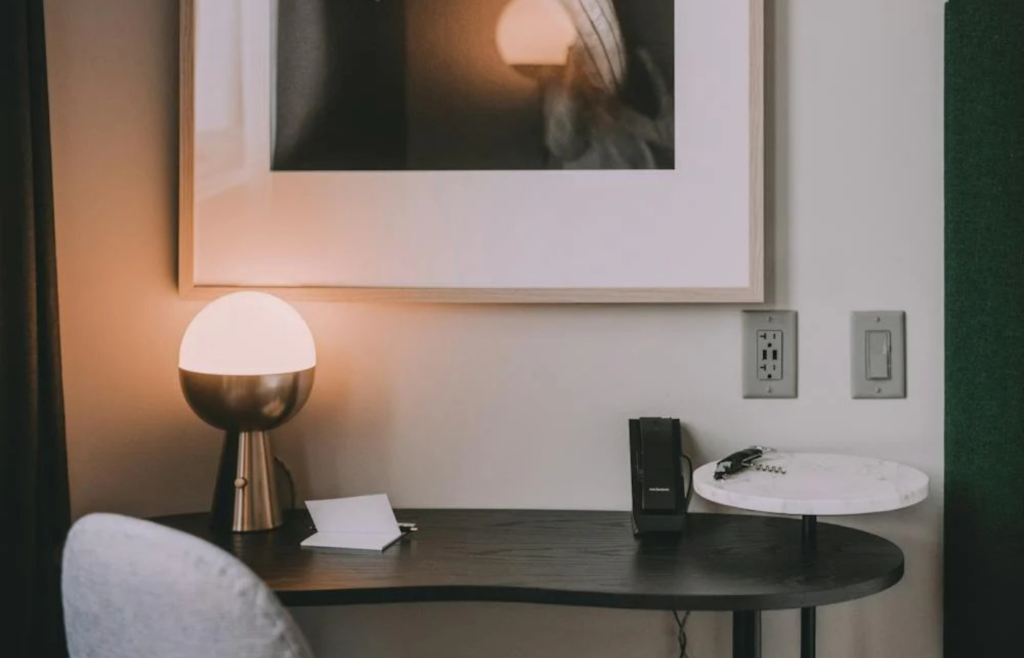 A timer plugged into a wall outlet controlling a lamp