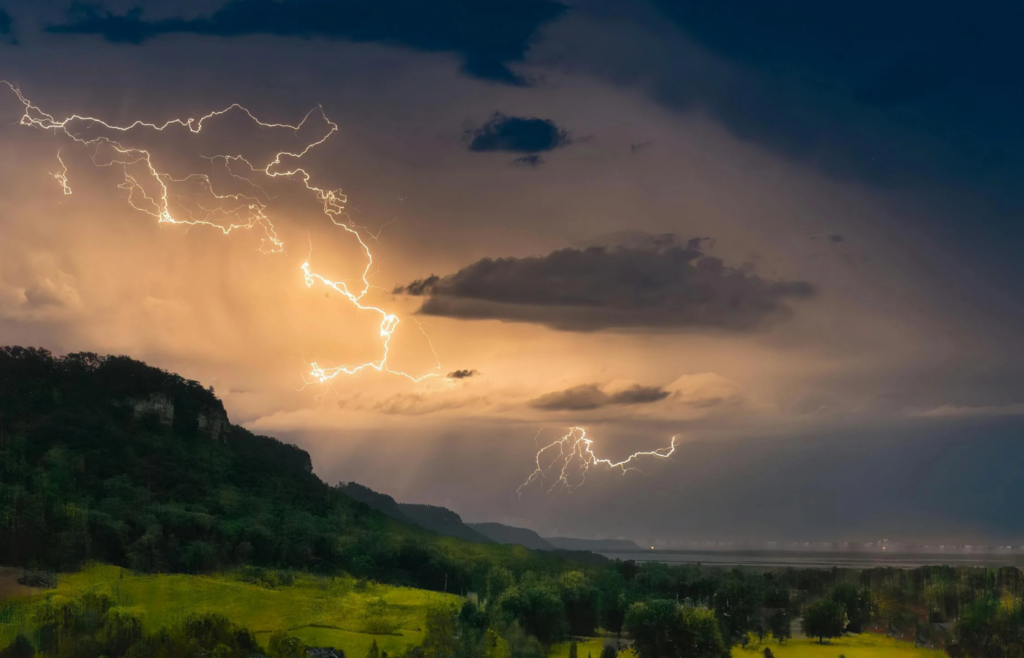 Lightning striking a forested hillside
