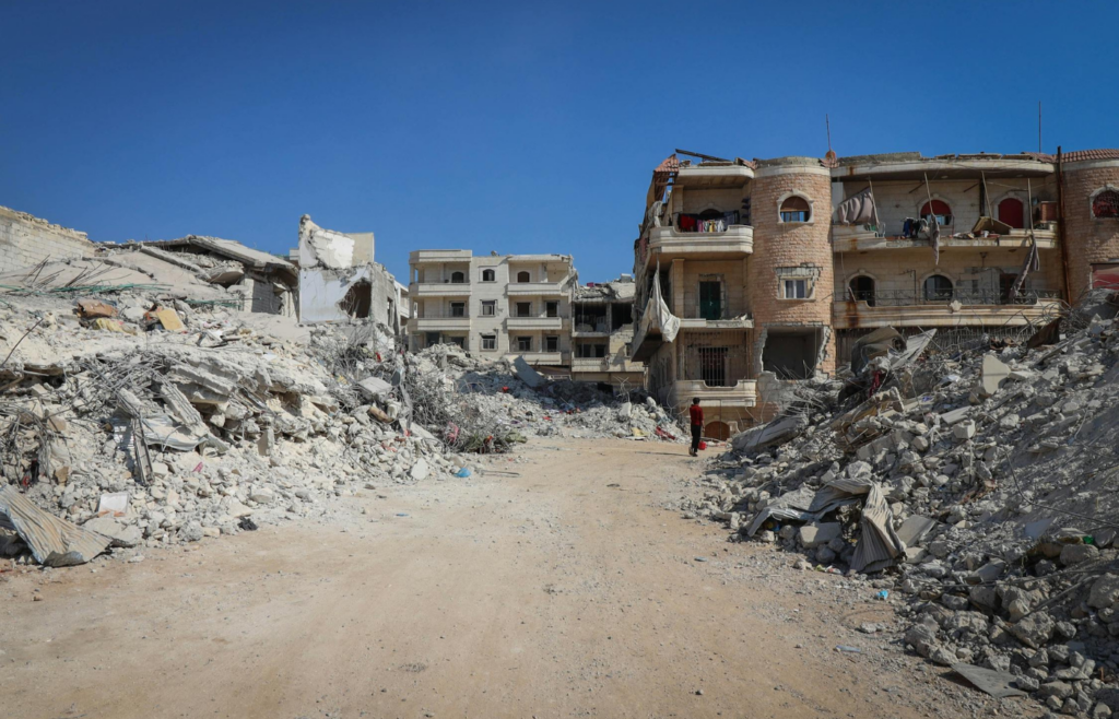 Collapsed buildings and cracked roads following an earthquake