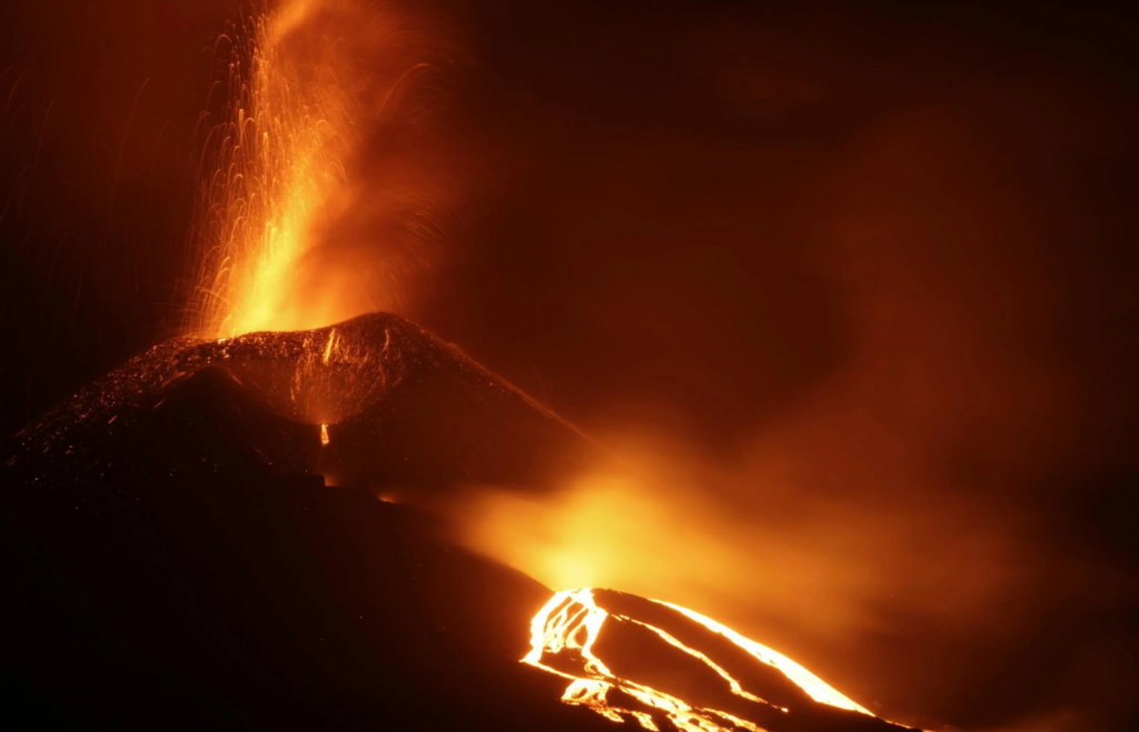Molten lava flowing from an erupting volcano