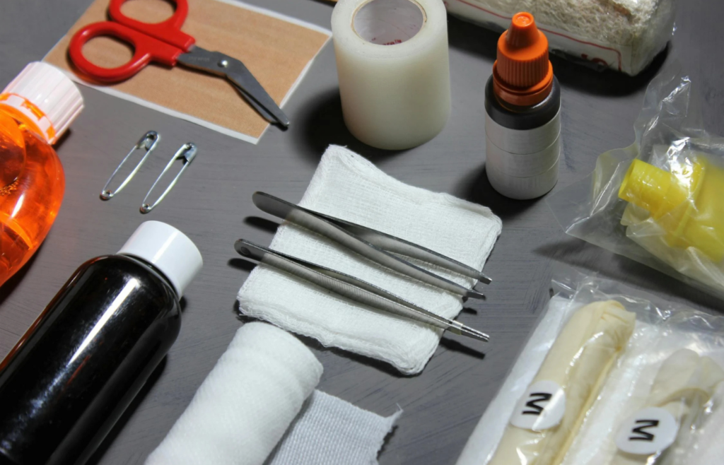 Open first aid kit displaying bandages, antiseptics, and medical tools.