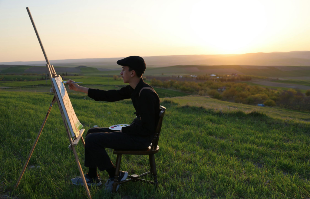 Someone painting on a canvas