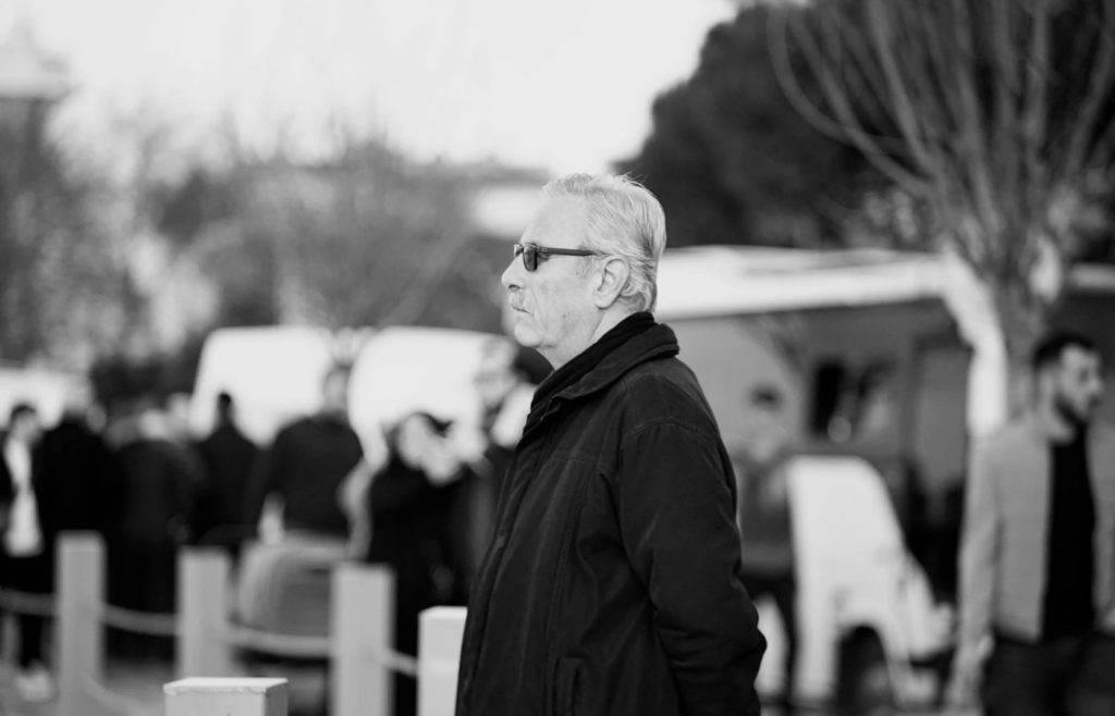 Person discreetly observing surroundings in a public place