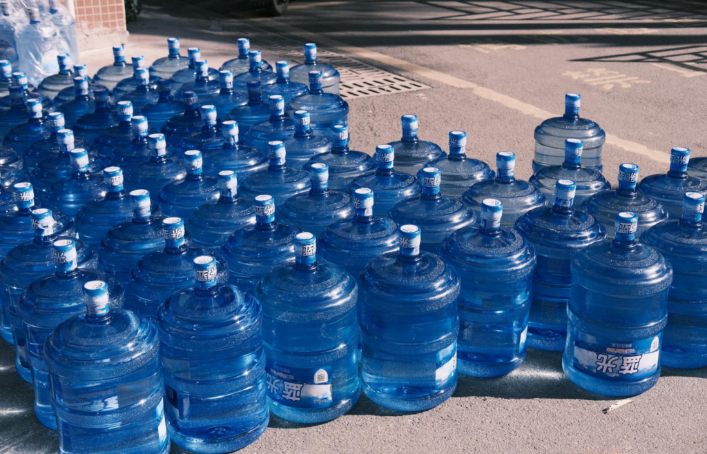 Clear plastic water bottles neatly stacked