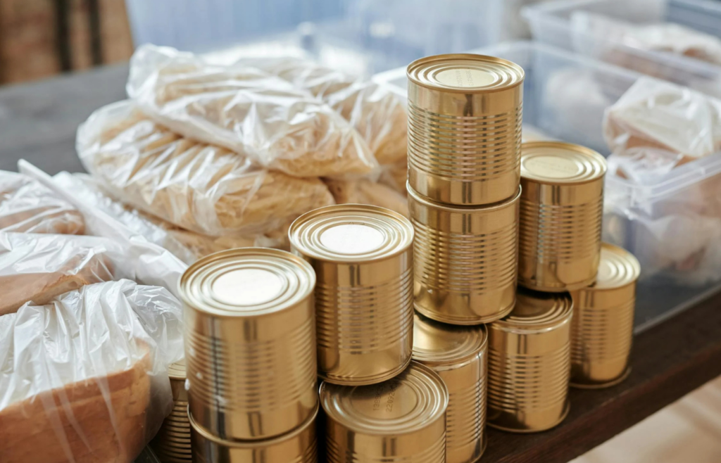 Assortment of canned goods and ready-to-eat foods on a pantry shelf