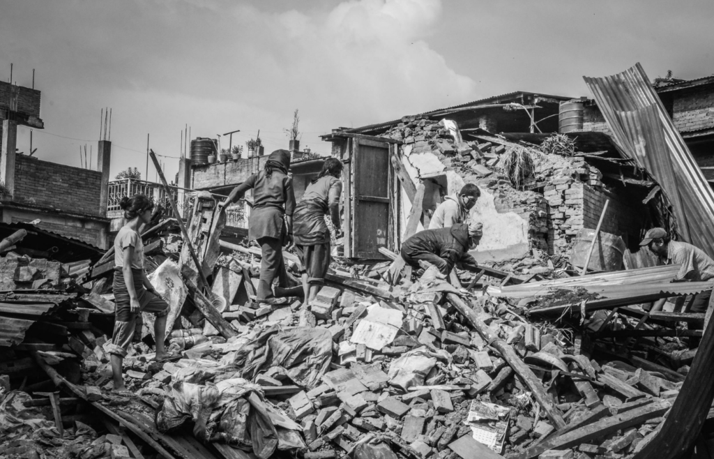 People on Debris of a House