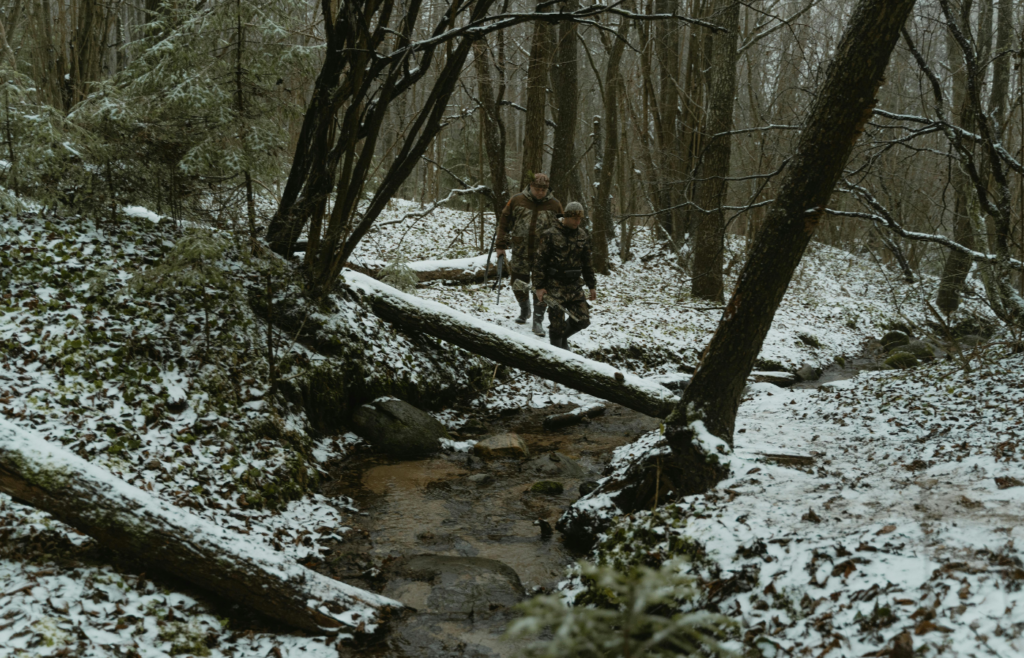 Soldiers walking on the woods holding rifles