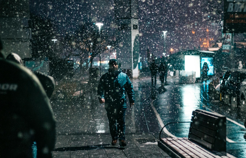 People Walking in Snow in City Downtown