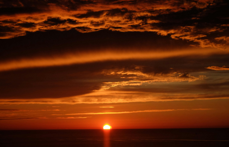 Red sunset over ocean horizon