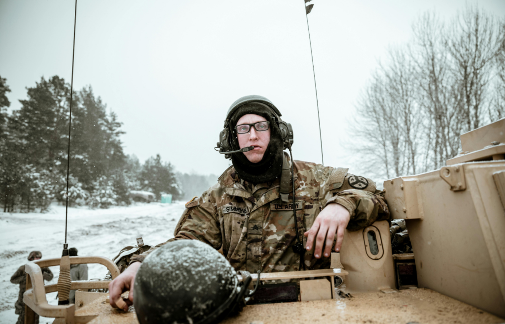 A military person riding a tank