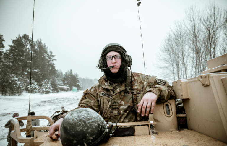 A military person riding a tank