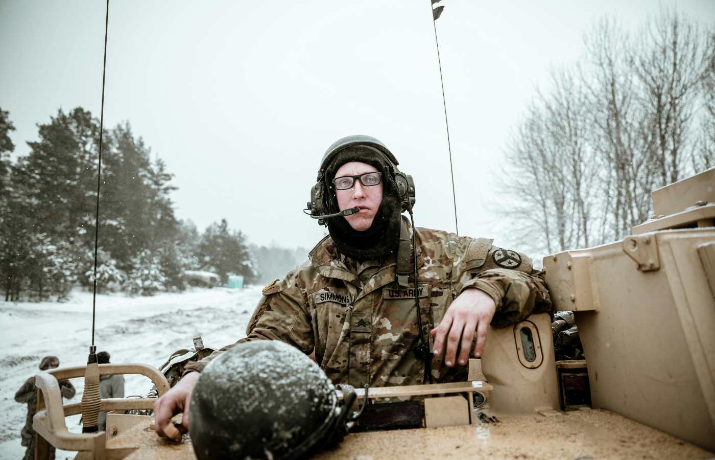 A military person riding a tank