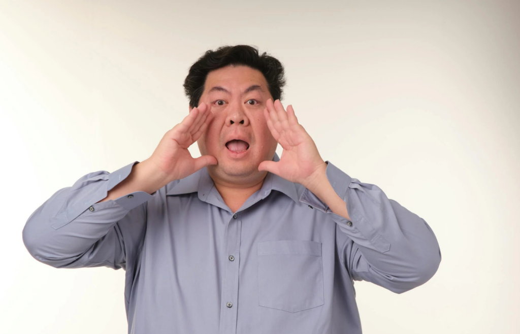 Person cupping hands around mouth, shouting