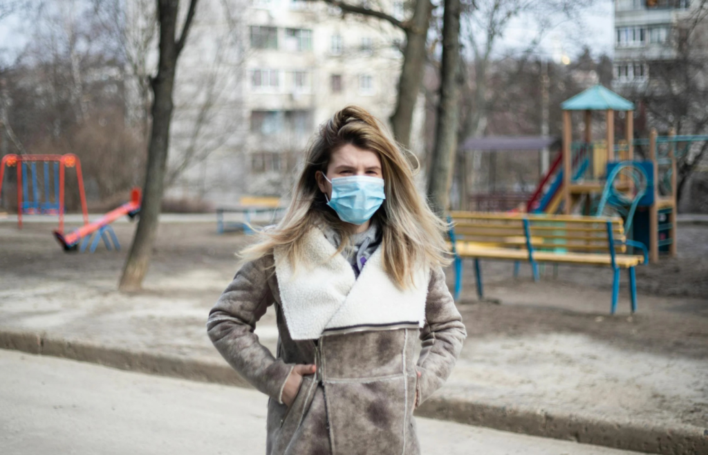 A beachgoer in Miami wearing a winter coat during a rare cold snap